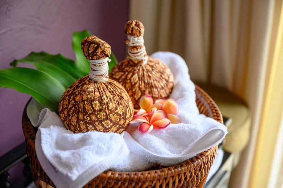 Warm herbal compress resting on a client's back during treatment